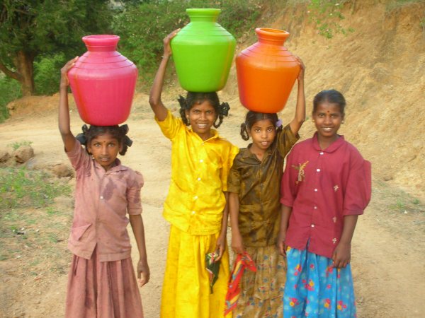 Girls carrying water in India, via Wikimedia Commons