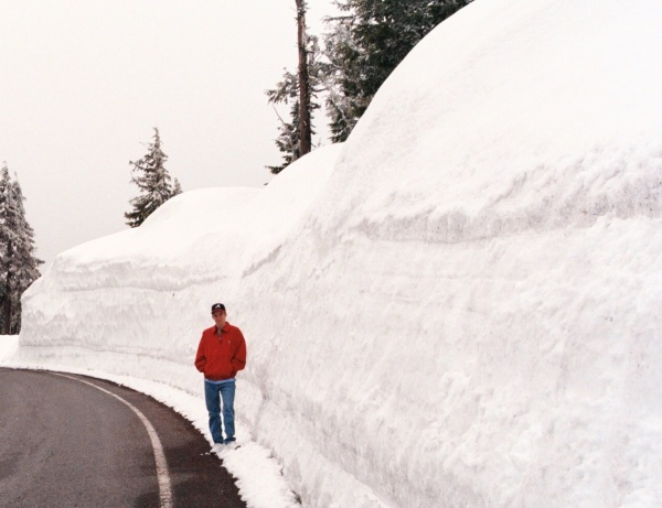 Snow to shovel? Remember, it could be worse! This is Drew at Crater Lake, Oregon, in June (yes, June) 2000.